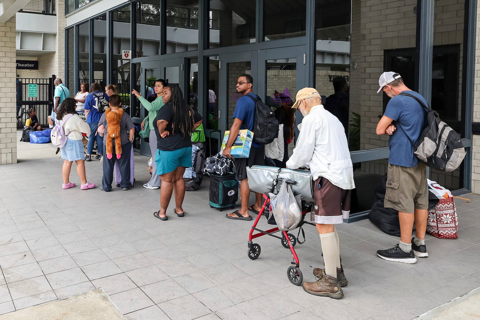 Pasco County evacuees await the opening of the shelter at River Ridge High School in preparation for Hurricane Milton on Monday, Oct. 7, 2024, in New Port Richey, Fla. (AP Photo/Mike Carlson)