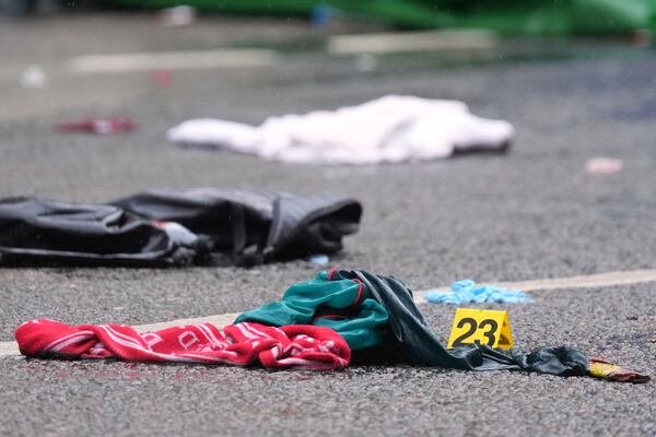 Evidence is marked near the site where a 53-year-old British man plowed a minivan into a crowd of Liverpool soccer fans who were celebrating the city's Premier League championship Monday, injuring more than 45 people in Liverpool, England, Tuesday, May 27, 2025.(AP Photo/Jon Super)