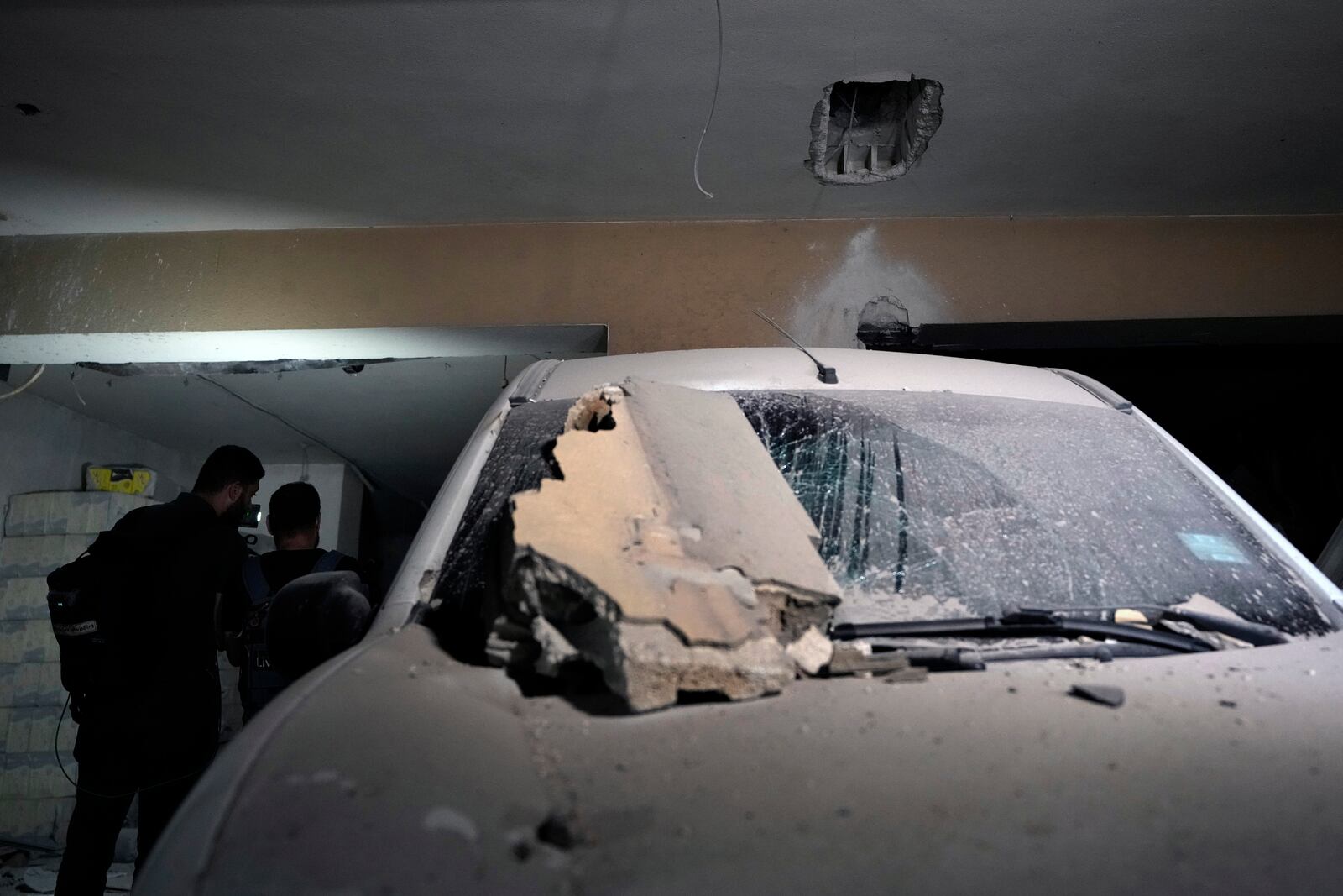 Journalists are given a tour at the site of an Israeli airstrike in Beirut's southern suburb, Monday, Sept. 23, 2024. (AP Photo/Bilal Hussein)