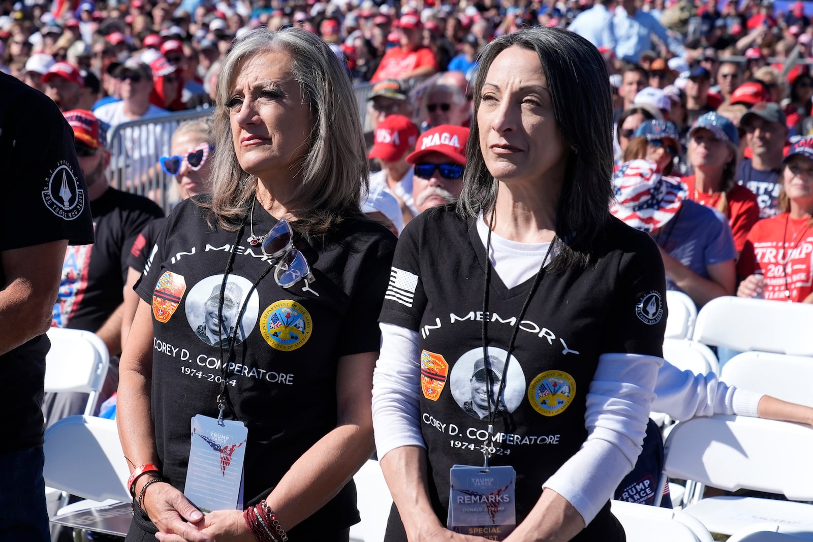 Kelly Comperatore-Meeder, left, and Dawn Comperatore-Schafer, sisters of firefighter Corey Comperatore, who died as he shielded family members from gunfire, attend a campaign event for Republican presidential nominee former President Donald Trump, at the Butler Farm Show, the site where a gunman tried to assassinate Trump in July, Saturday, Oct. 5, 2024, in Butler, Pa. (AP Photo/Alex Brandon)