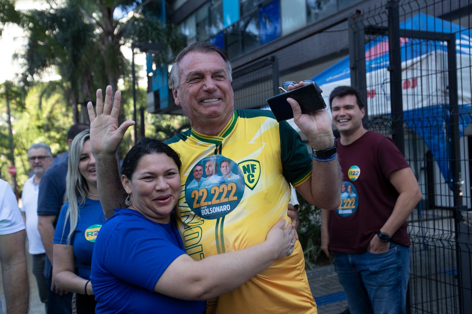 A supporter hugs former Brazilian President Jair Bolsonaro, center, as he campaigns for Rio de Janeiro mayoral candidate Alexandre Ramagem during the municipal elections in Rio de Janeiro, Sunday, Oct. 6, 2024. (AP Photo/Bruna Prado)