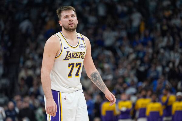 Los Angeles Lakers guard Luka Doncic (77) reacts after a foul called on the Lakers during the first half of Game 4 of an NBA basketball first-round playoff series against the Minnesota Timberwolves, Sunday, April 27, 2025, in Minneapolis. (AP Photo/Abbie Parr)