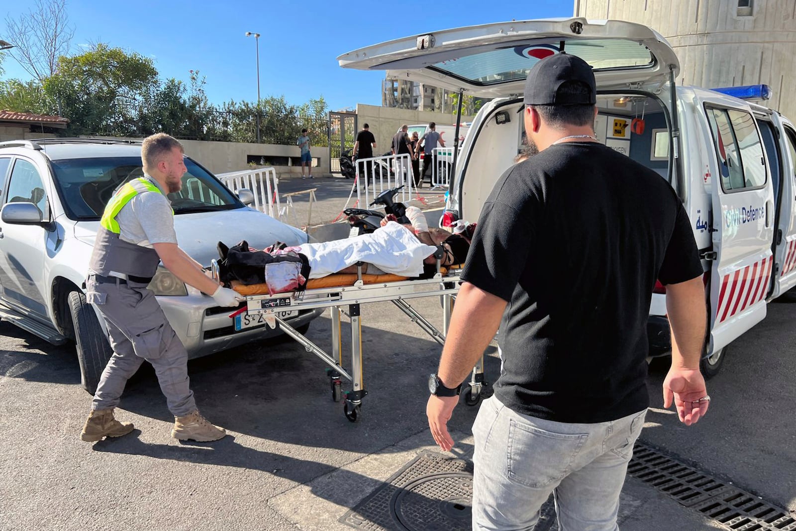 Civil Defense first-responders carry a wounded man whose handheld pager exploded at al-Zahraa hospital in Beirut, Lebanon, Tuesday, Sept. 17, 2024. (AP Photo/Hussein Malla)