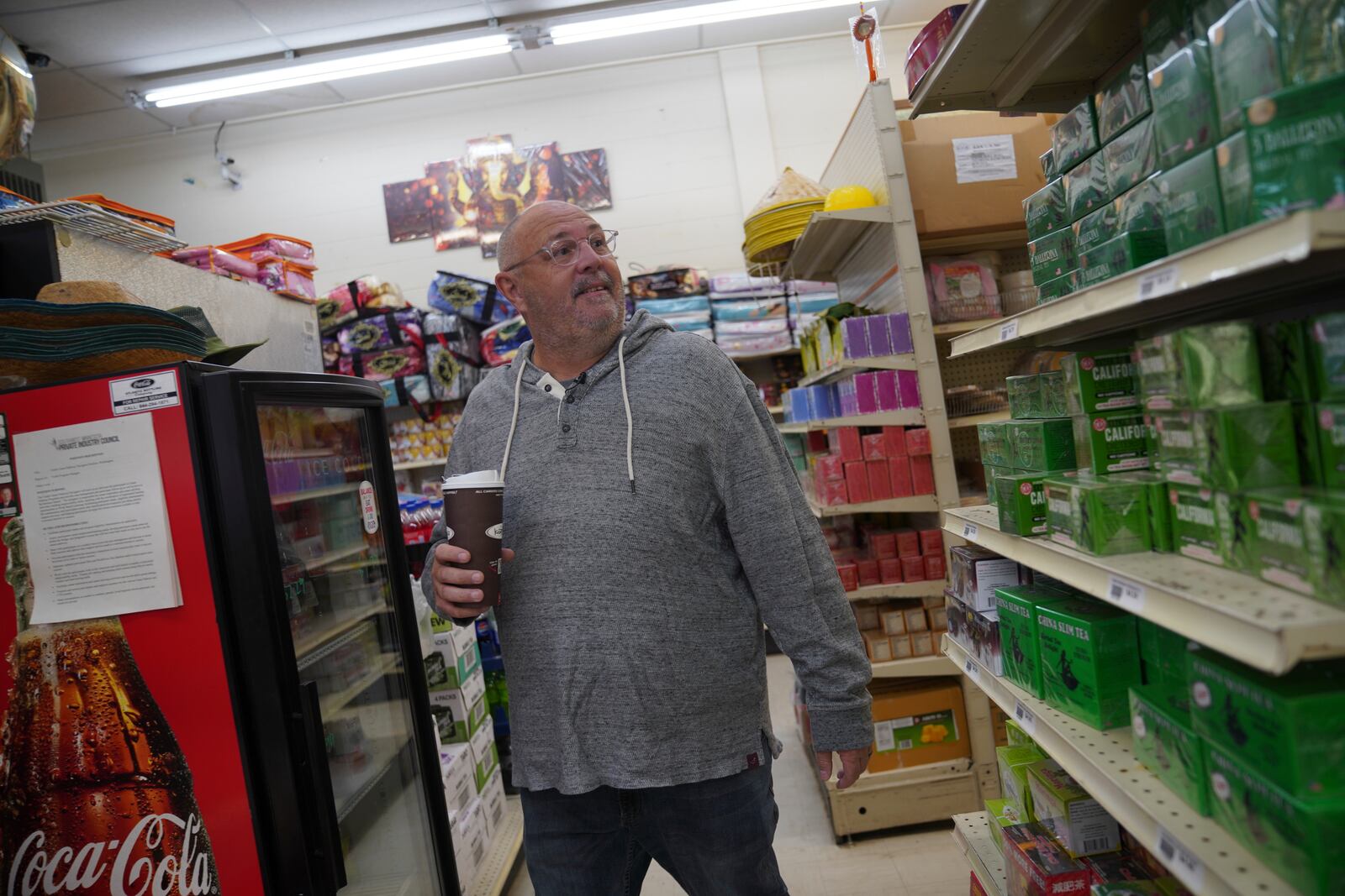 Chad Cummings, a city councilor and co-owner of the local radio stations, walks through Top Asian Food and Deli in Worthington, Minn., on Saturday, Oct. 19, 2024. (AP Photo/Jessie Wardarski)