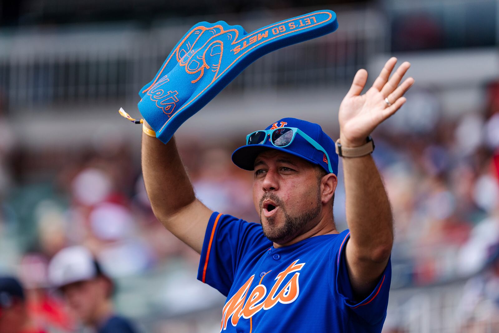 A fan dances in the stands during a rally in the eighth inning of a baseball game between the New York Mets and the Atlanta Braves, Monday, Sept. 30, 2024, in Atlanta. (AP Photo/Jason Allen)