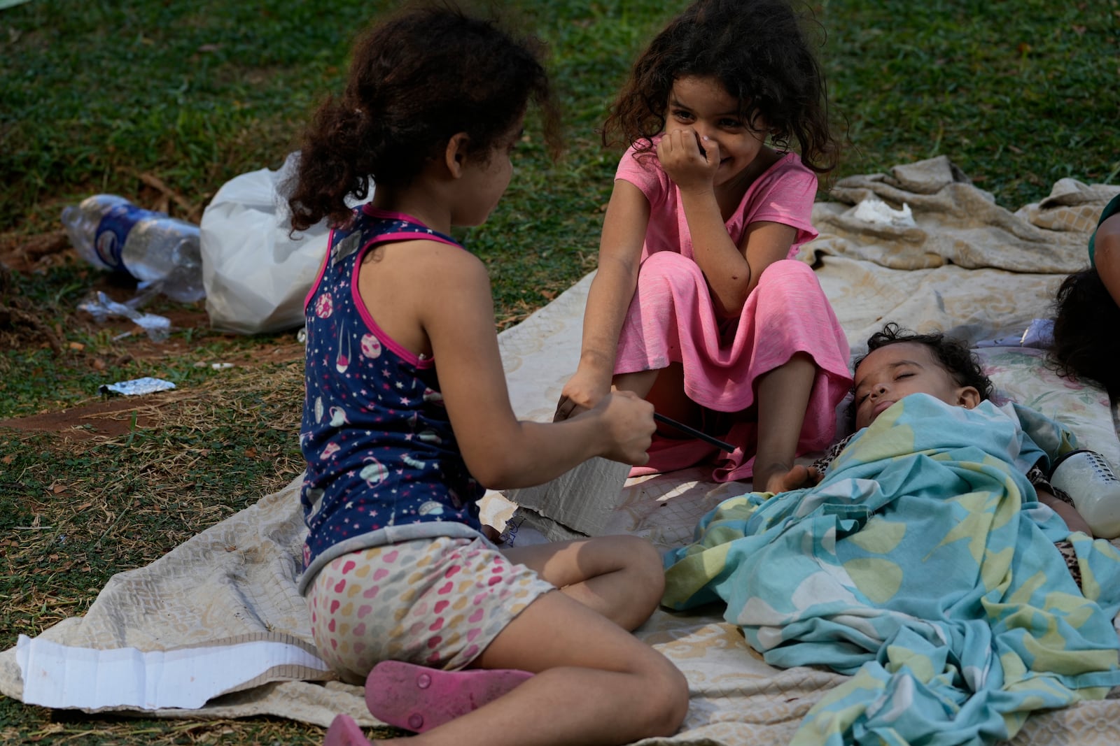 Kids who fled with their families the southern suburb of Beirut amid ongoing Israeli airstrikes, rest in a park in downtown Beirut, Lebanon, Saturday, Sept. 28, 2024. (AP Photo/Hussein Malla)