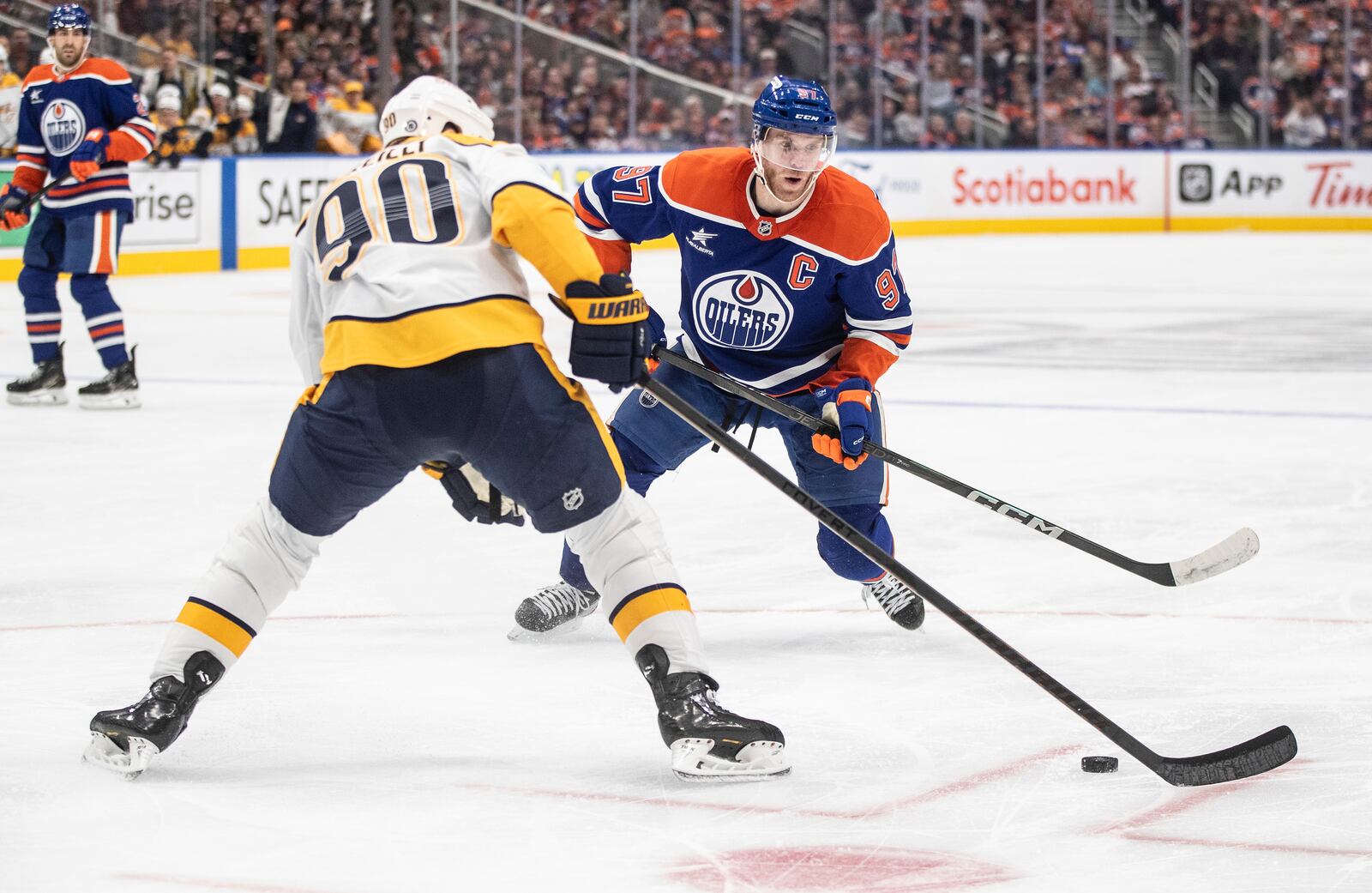 Nashville Predators' Ryan O'Reilly (90) and Edmonton Oilers' Connor McDavid (97) battle for the puck during the second period of an NHL hockey game, Thursday, Nov. 14, 2024 in Edmonton, Alberta. (Jason Franson/The Canadian Press via AP)