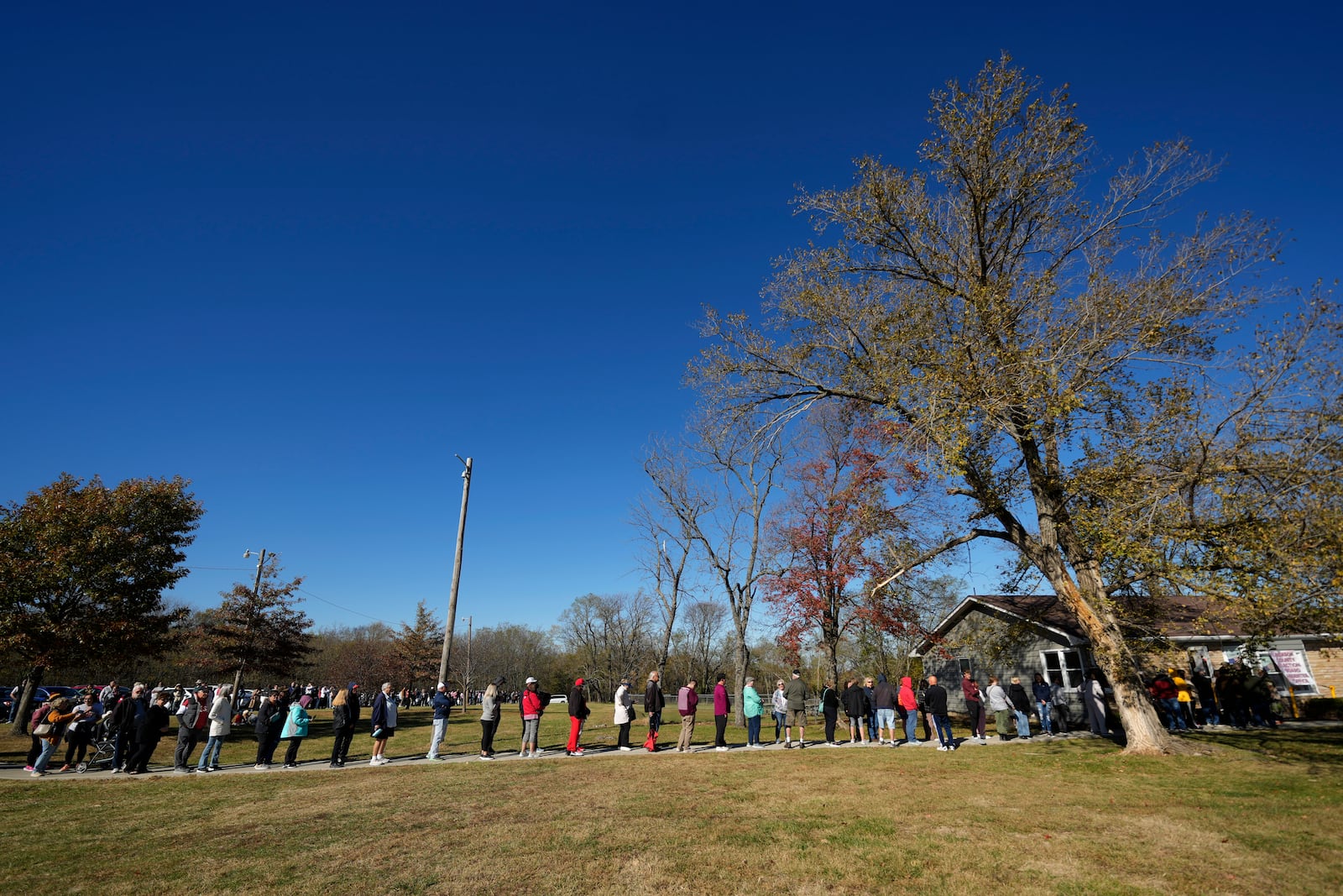 People wait in line to cast their ballots at an early voting location, Thursday, Oct. 31, 2024, in Blue Springs, Mo. (AP Photo/Charlie Riedel)