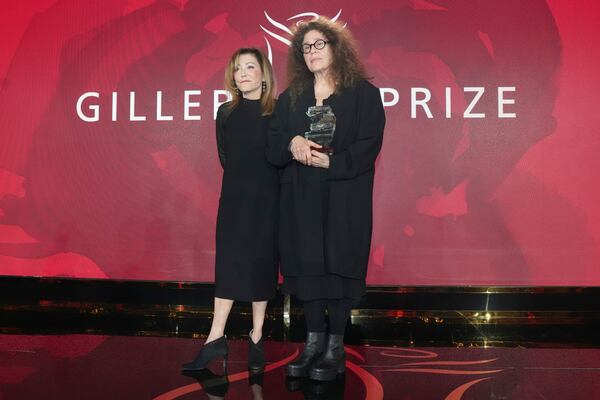 Anne Michaels, right, stands with Elana Rabinovitch, executive director of Giller Prize, as she accepts the Giller Prize for her book "Held" at a ceremony in Toronto, Monday, Nov. 18, 2024. (Chris Young/The Canadian Press via AP)