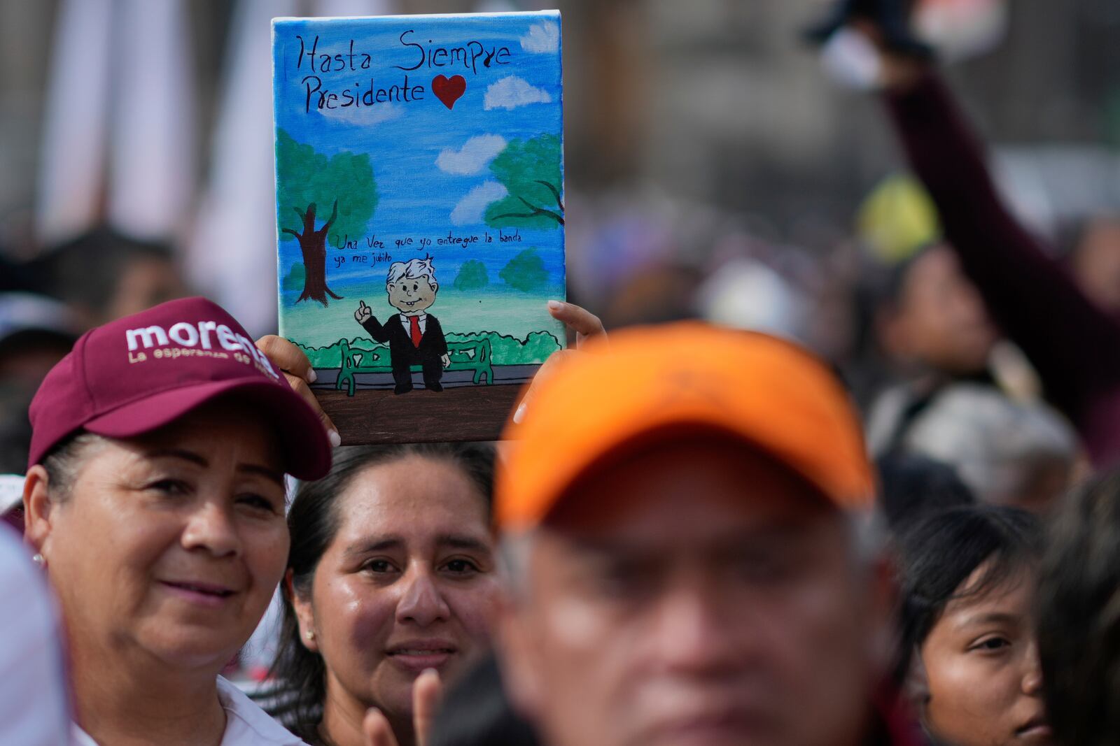 A supporter of new President Claudia Sheinbaum holds a painting of outgoing President Andrés Manuel López Obrador that reads in Spanish "Farewell, President" during a rally in the Zócalo, Mexico City's main square, Tuesday, Oct. 1, 2024. (AP Photo/Eduardo Verdugo)