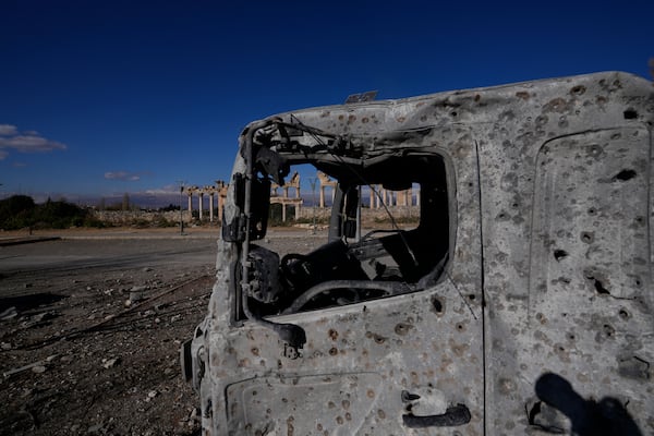 A damaged vehicle seen in front of part of the Roman temples of Baalbek in eastern Lebanon, Thursday, Nov. 28, 2024. (AP Photo/Hassan Ammar)