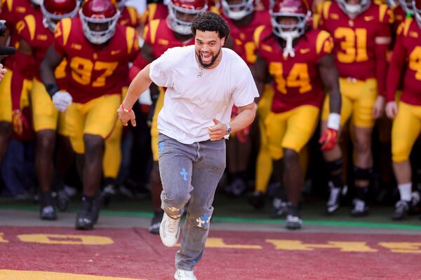 Former Southern California quarterback and current Chicago Bear quarterback Caleb Williams leads the team onto the field during the first half of an NCAA football game against Notre Dame Saturday, Nov. 30, 2024, in Los Angeles. (AP Photo/Ryan Sun)