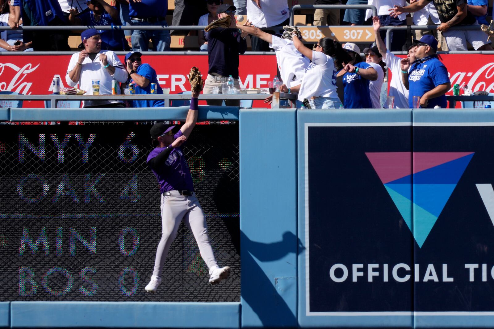 Colorado Rockies left fielder Nolan Jones can't reach a ball hit by Los Angeles Dodgers' Kiké Hernández for a two-run home run during the seventh inning of a baseball game, Sunday, Sept. 22, 2024, in Los Angeles. (AP Photo/Mark J. Terrill)