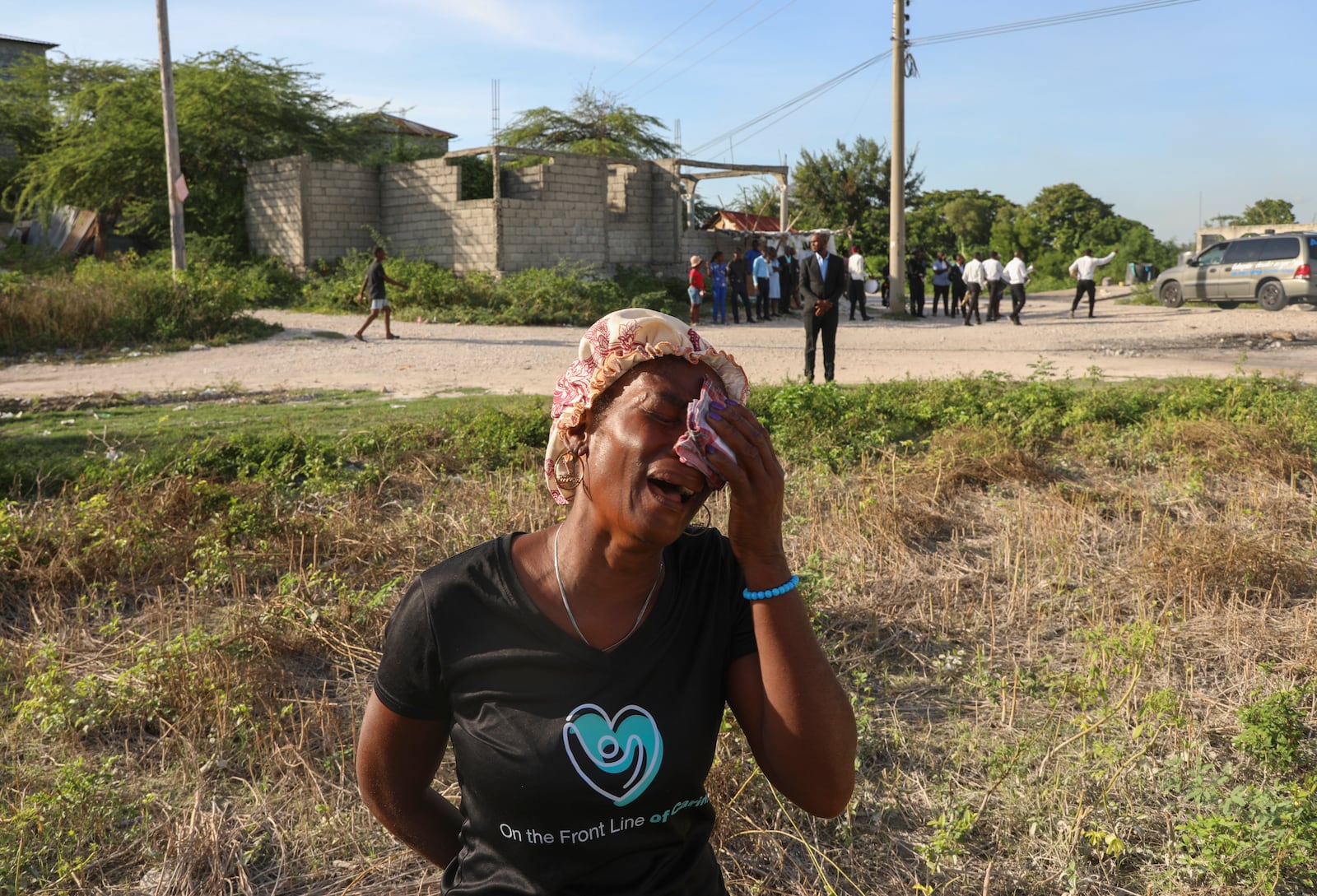 A neighbor cries during the funeral of Jean Louis Jeune Gracien, who was killed during an attack by armed gangs, in Pont-Sonde, Haiti, Tuesday, Oct. 8, 2024. (AP Photo/Odelyn Joseph)