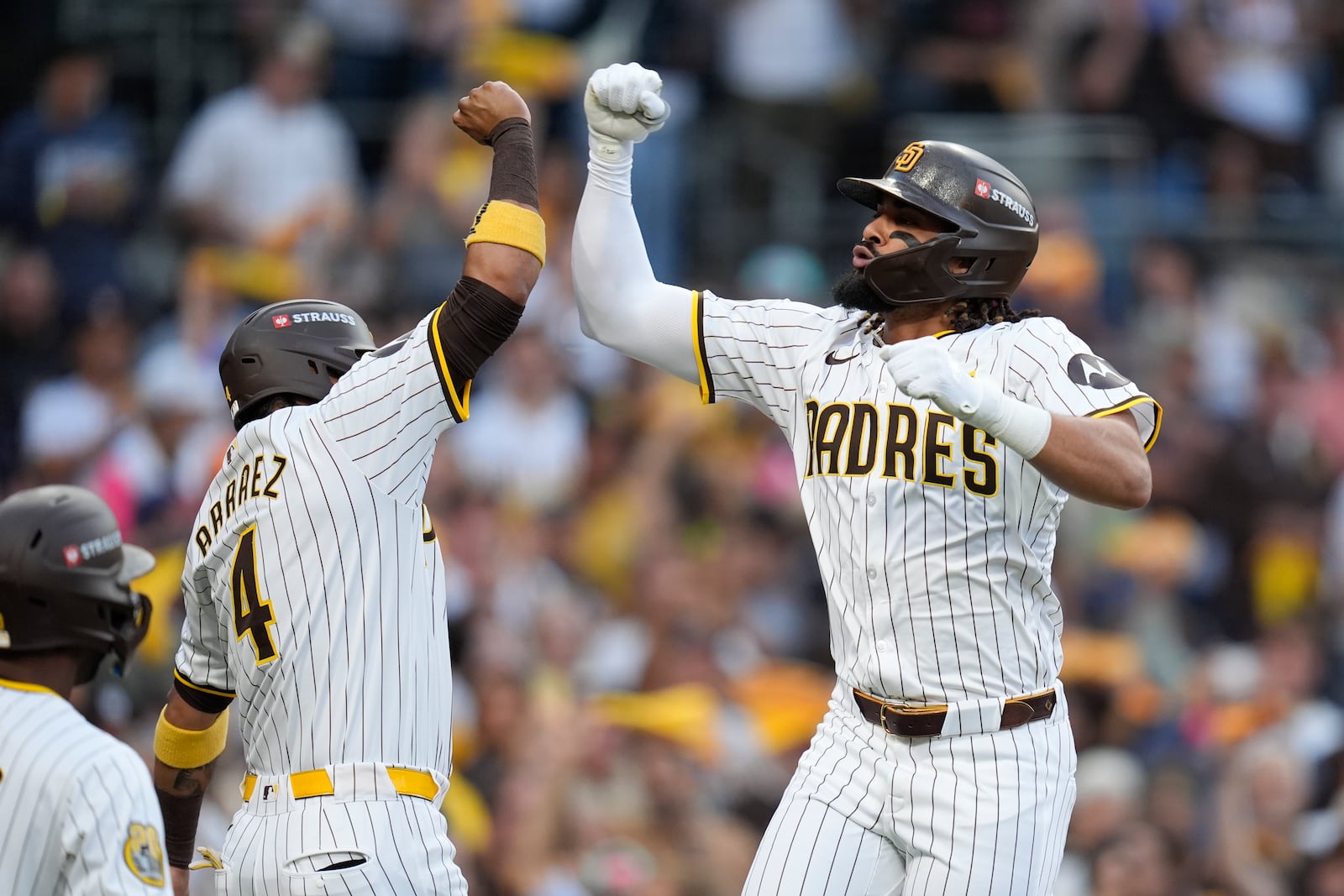 San Diego Padres' Fernando Tatis Jr., right, celebrates with Luis Arraez (4) after hitting a two-run home run during the first inning in Game 1 of an NL Wild Card Series baseball game against the Atlanta Braves, Tuesday, Oct. 1, 2024, in San Diego. (AP Photo/Gregory Bull)