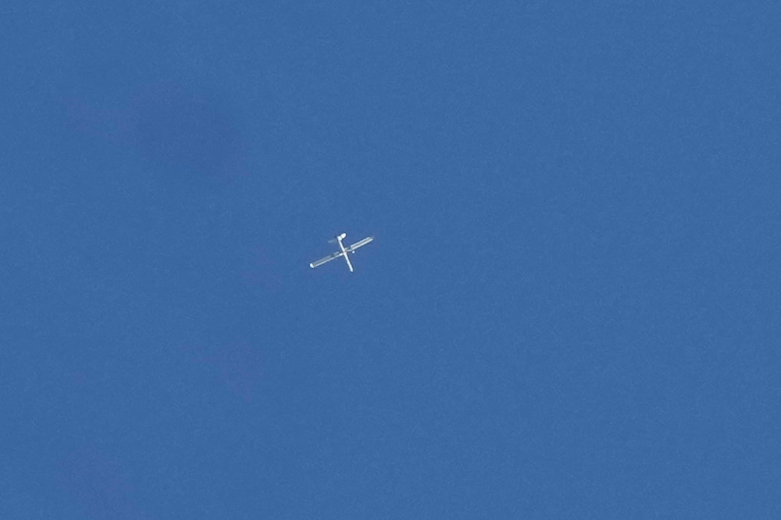 FILE - An Israeli reconnaissance drone flies over the funeral procession of four Hezbollah fighters who were killed Tuesday after their handheld devices exploded in the southern suburb of Beirut, Wednesday, Sept. 18, 2024. (AP Photo/Bilal Hussein, File)