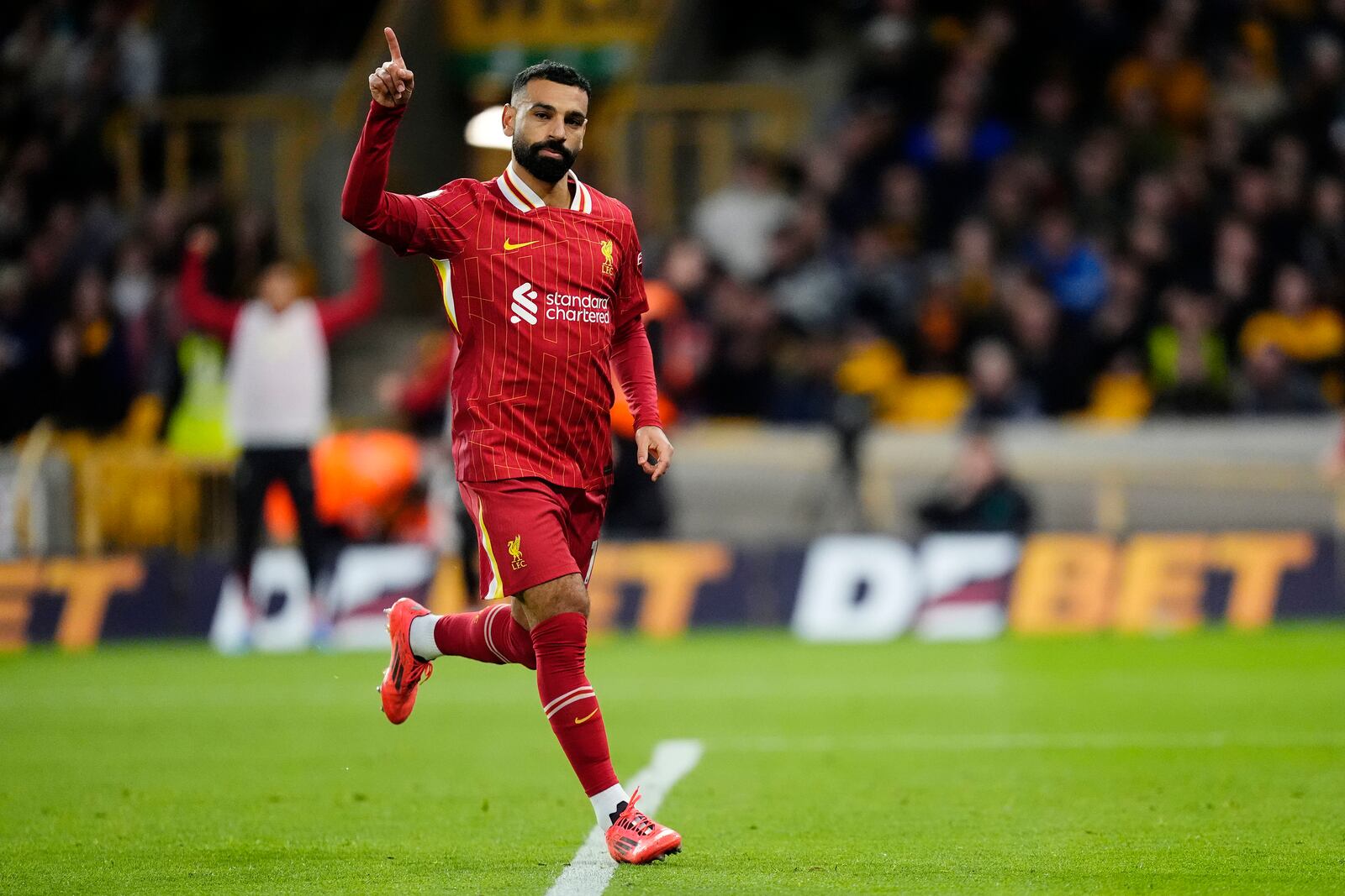 Liverpool's Mohamed Salah celebrates scoring his side's second goal of the game during the English Premier League soccer match between Wolverhampton Wanderers and Liverpool at the Molineux Stadium in Wolverhampton, England, Saturday, Sept. 28, 2024. (Nick Potts/PA via AP)