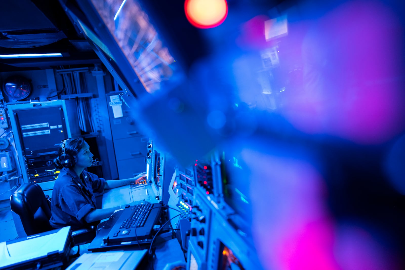 FILE -Crew members work in the combat information center of the Arleigh Burke-class guided missile destroyer USS Laboon during a deployment in the Red Sea, June 12, 2024. (AP Photo/Bernat Armangue, File)