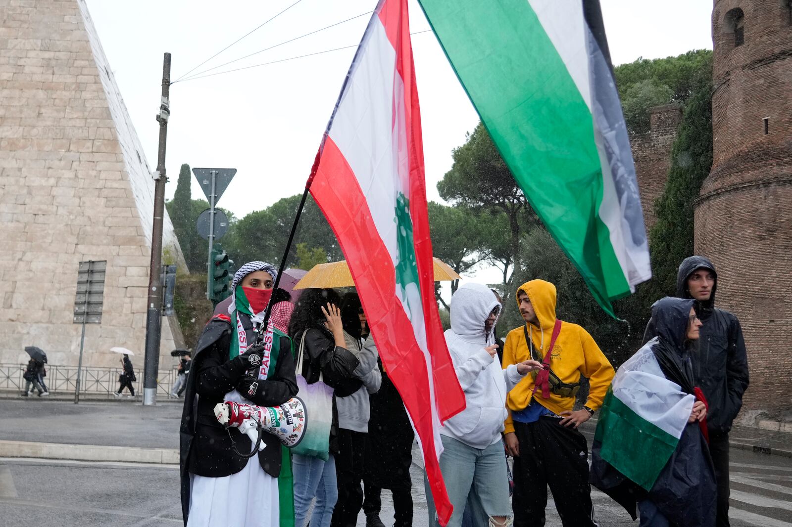 People stand during a protest in Rome, Saturday, Oct. 5, 2024. Pro-palestinians people take to the street in an unauthorised march in the centre of Rome two days ahead of the first anniversary of the Oct. 7. (AP Photo/Andrew Medichini)