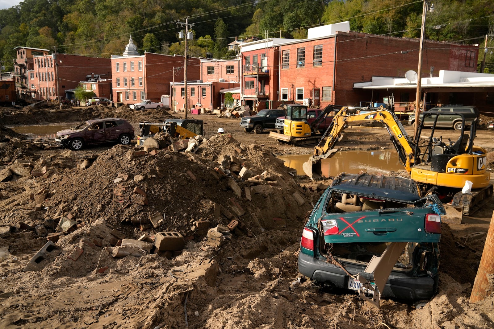 Debris left in the aftermath of Hurricane Helene fills the street Tuesday, Oct. 1, 2024, in Marshall, N.C. (AP Photo/Jeff Roberson)