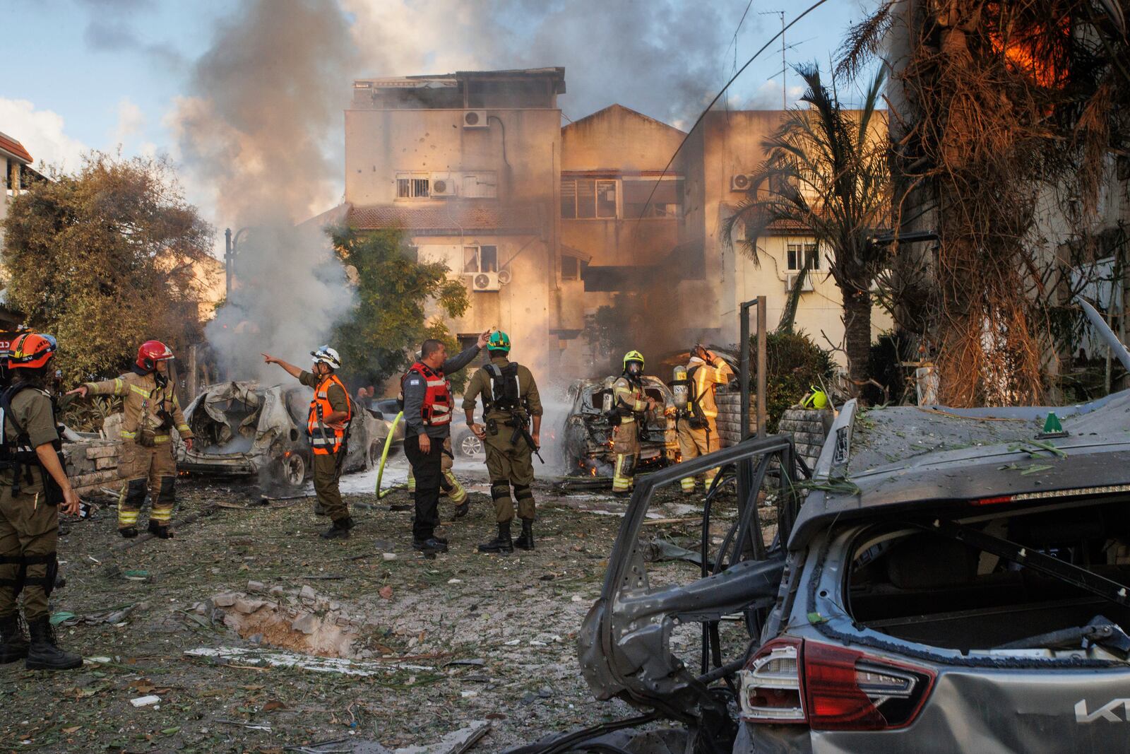 Israeli security forces work at the site hit by a rocket fired from Lebanon, in Kiryat Bialik, northern Israel, on Sunday, Sept. 22, 2024. (AP Photo/Gil Nechushtan)