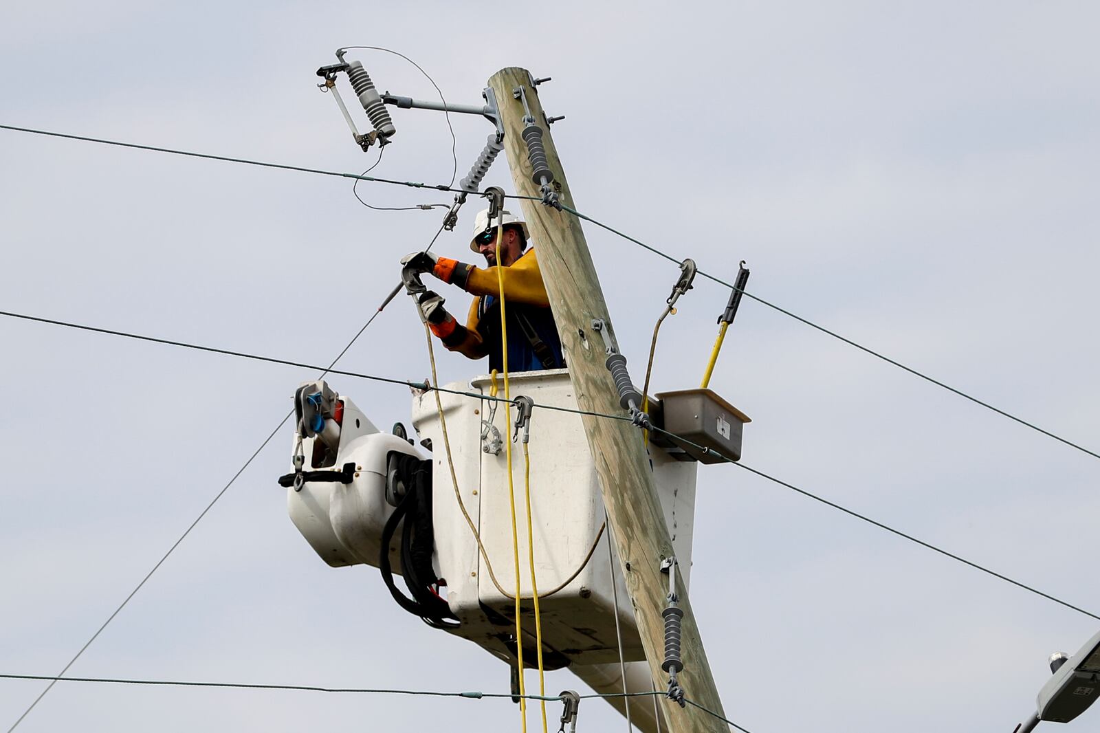 A Dominion Energy lineman works on a power line in the aftermath of Hurricane Helene Sunday, Sept. 29, 2024, in North Augusta, S.C. (AP Photo/Artie Walker Jr.)