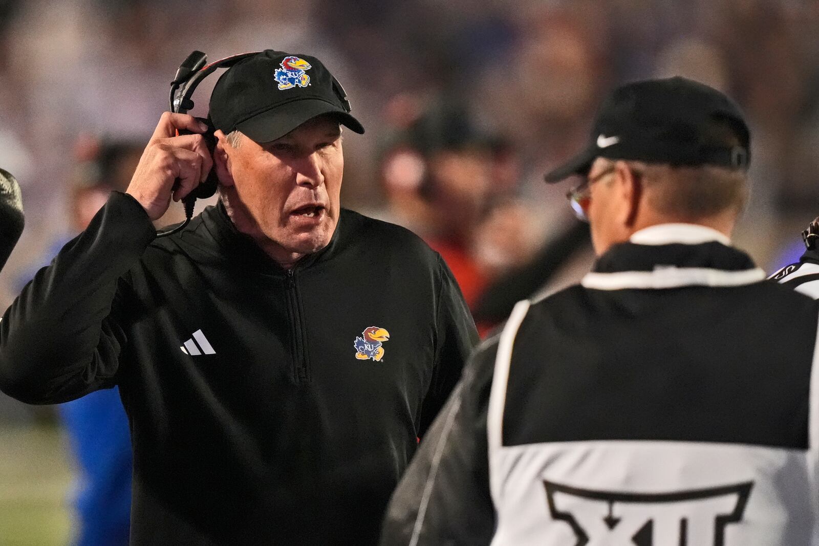 Kansas head coach Lance Leipold talks to an official during the first half of an NCAA college football game against Kansas State Saturday, Oct. 26, 2024, in Manhattan, Kan. (AP Photo/Charlie Riedel)