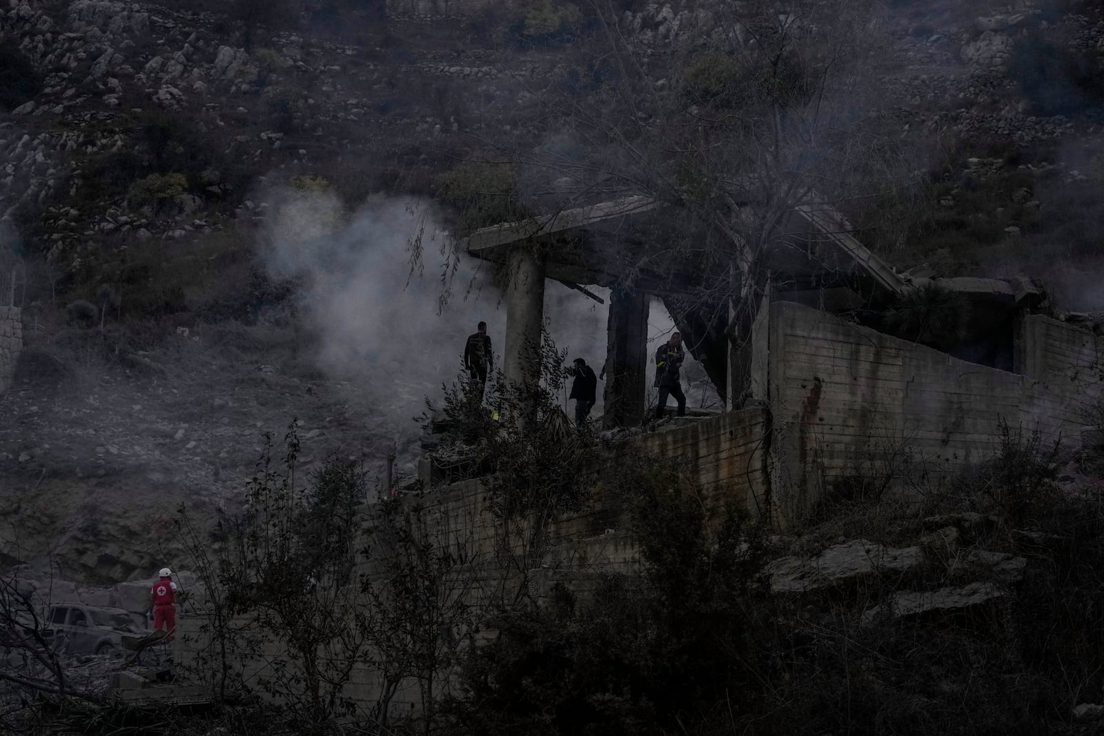 Rescue workers search for victims at a house hit in an Israeli airstrike in Baalchmay village east of Beirut, Lebanon, Tuesday, Nov. 12, 2024. (AP Photo/Hassan Ammar)