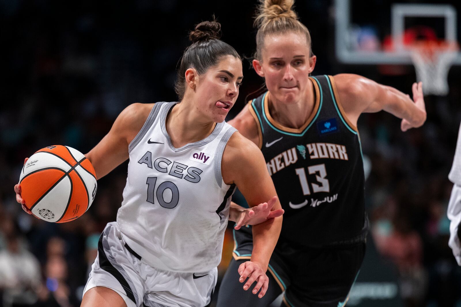 Las Vegas Aces guard Kelsey Plum (10) drives past New York Liberty forward Leonie Fiebich (13) during the second half of a WNBA basketball second-round playoff game, Sunday, Sept. 29, 2024, in New York. (AP Photo/Corey Sipkin)