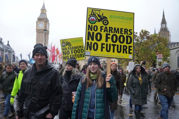 The National Farmers' Union members attend a protest against the planned changes to tax rules, in London, Tuesday, Nov. 19, 2024. (AP Photo/Kin Cheung)