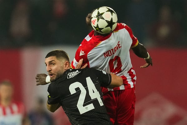 Stuttgart's Jeff Chabot, left, and Red Star's Cherif Ndiaye fight for the ball during the Champions League opening phase soccer match between Red Star and Stuttgart at the Rajko Mitic Stadium in Belgrade, Serbia, Wednesday, Nov. 27, 2024. (AP Photo/Darko Vojinovic)