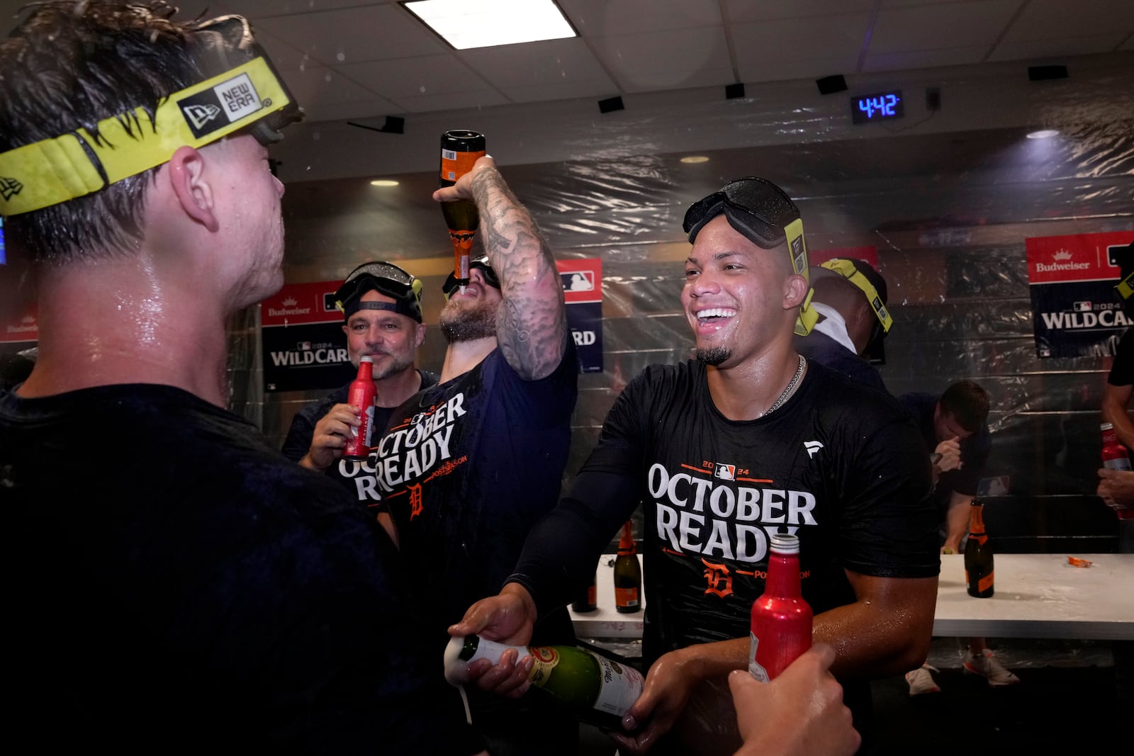 Detroit Tigers' Wenceel Perez, right, celebrates with the team in the clubhouse after defeating the Houston Astros in Game 2 to clinch the AL Wild Card baseball series, Wednesday, Oct. 2, 2024, in Houston. (AP Photo/Kevin M. Cox)