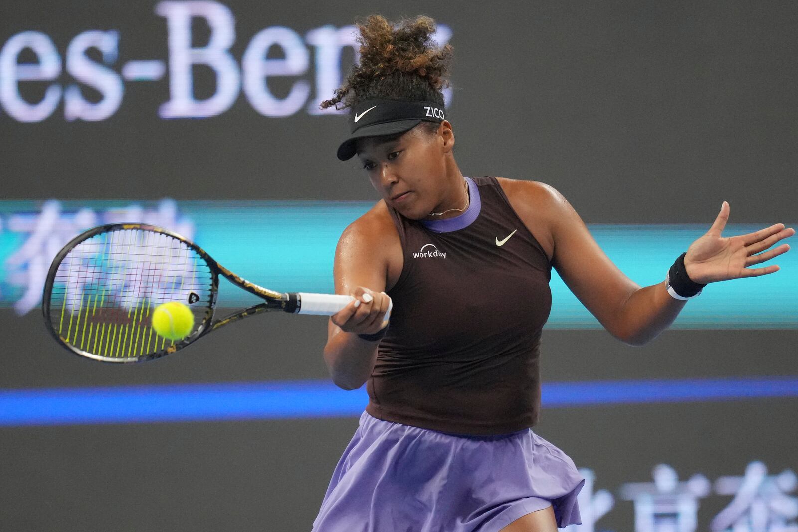 Naomi Osaka of Japan returns a shot to Coco Gauff of the United States in a women's singles match for the China Open tennis tournament held at the National Tennis Center in Beijing, Tuesday, Oct. 1, 2024.(AP Photo/Achmad Ibrahim)