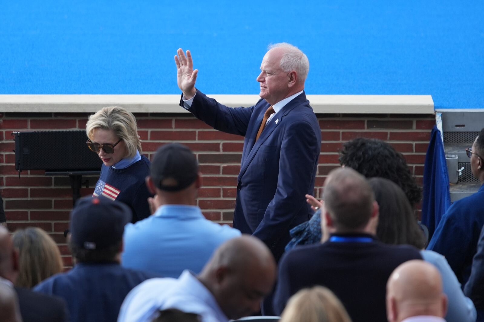 Minnesota Gov. Tim Walz waves as he arrives ahead of Vice President Kamala Harris delivering a concession speech for the 2024 presidential election, Wednesday, Nov. 6, 2024, on the campus of Howard University in Washington. (AP Photo/Stephanie Scarbrough)