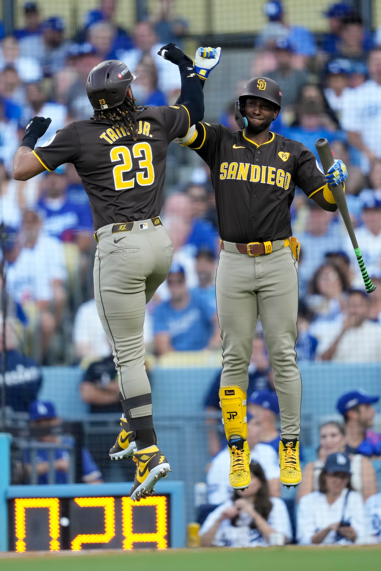 San Diego Padres' Fernando Tatis Jr., left, celebrates his solo home run with Jurickson Profar during the first inning in Game 2 of a baseball NL Division Series against the Los Angeles Dodgers, Sunday, Oct. 6, 2024, in Los Angeles.