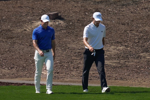 Rory McIlroy of Northern Ireland, left, and Rasmus Højgaard of Denmark walk to take their second shot on 4th hole in the final round of World Tour Golf Championship in Dubai, United Arab Emirates, Sunday, Nov. 17, 2024. (AP Photo/Altaf Qadri)