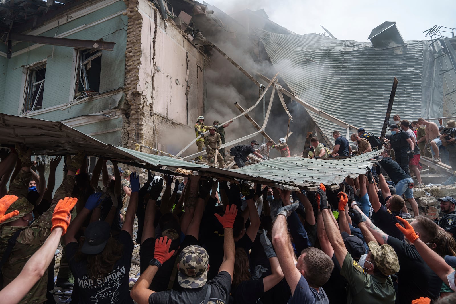 FILE - Rescuers work together to clear debris during a search operation for survivors at the Okhmatdyt children's hospital that was hit by a Russian missile, in Kyiv, Ukraine, July 8, 2024. (AP Photo/Evgeniy Maloletka, File)