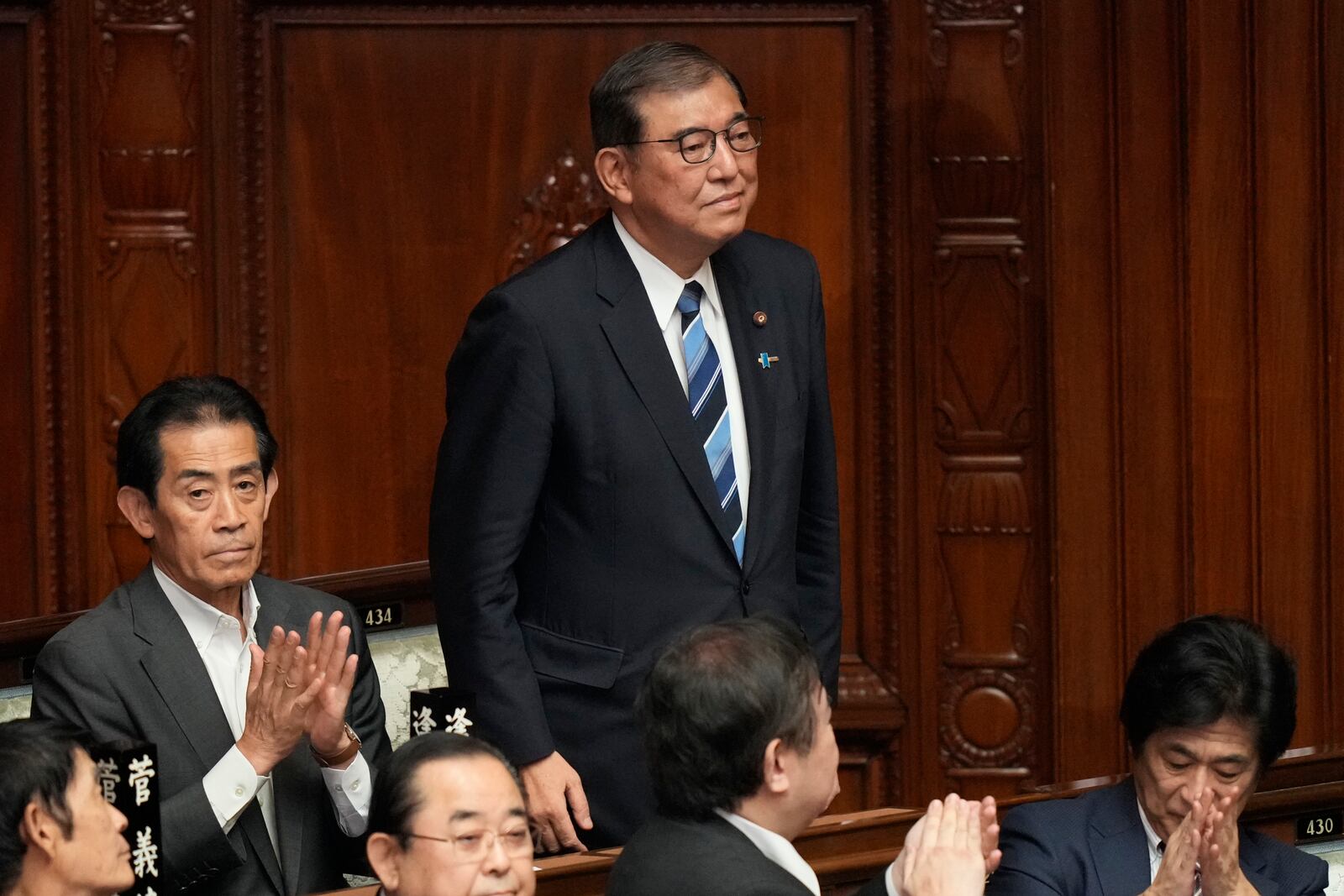 Shigeru Ishiba, center, the head of Japan's ruling party, the Liberal Democratic Party, is applauded after being elected as Japan's prime minister at the extraordinary session of parliament's lower house Tuesday, Oct. 1, 2024, in Tokyo. (AP Photo/Eugene Hoshiko)