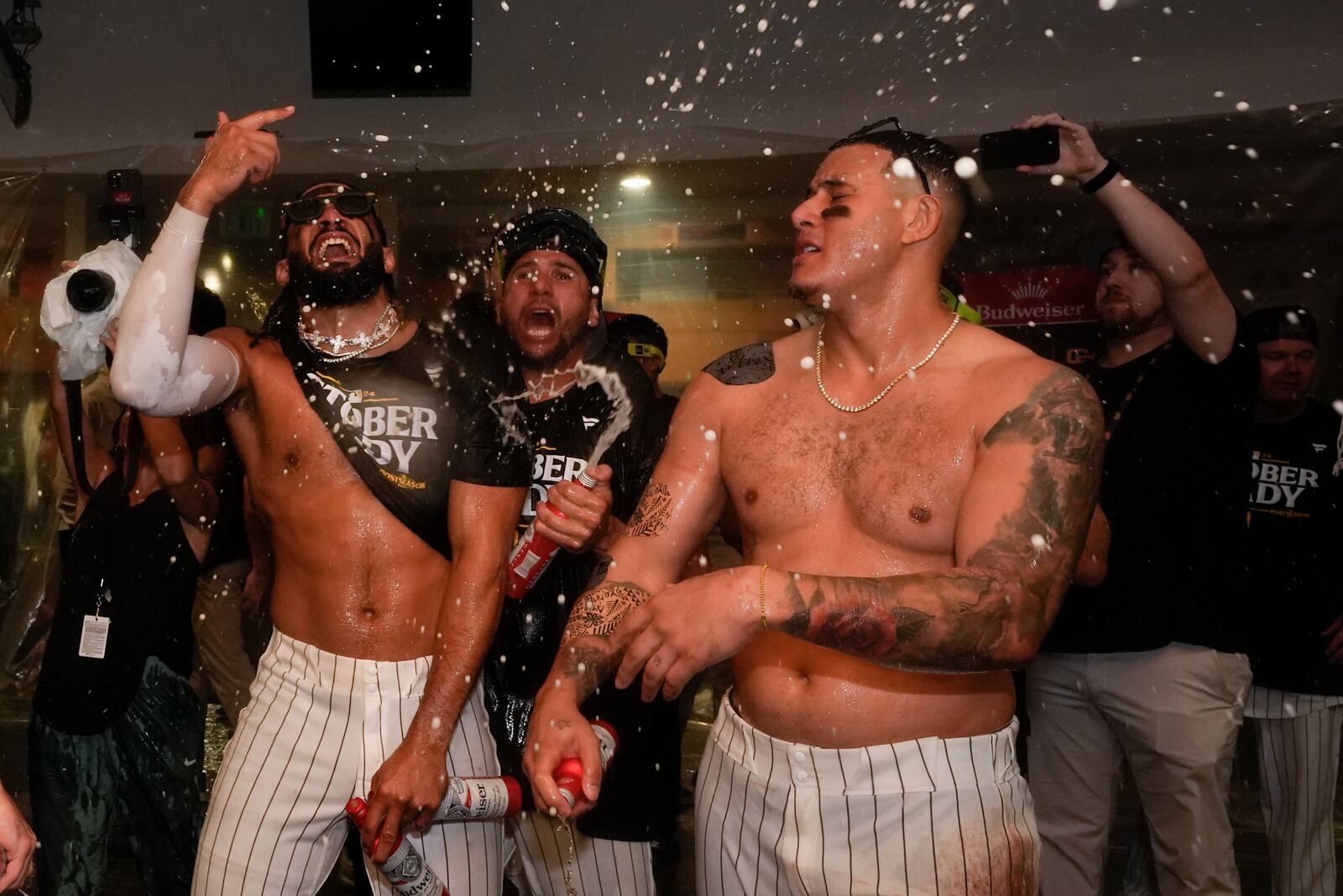 San Diego Padres players celebrate in the dugout after defeating the Atlanta Braves in Game 2 of an NL Wild Card Series baseball game Wednesday, Oct. 2, 2024, in San Diego. (AP Photo/Gregory Bull)