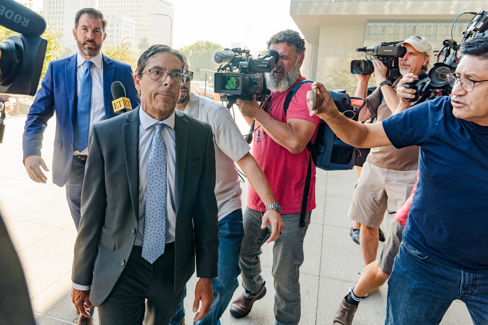 Dr. Mark Chavez, a physician from San Diego, second from left, who is charged in connection with actor Matthew Perry's death from an accidental ketamine overdose, with his criminal defense attorney Matthew Binninger, far left, arrive for a change of plea hearing at the United States Courthouse in Los Angeles on Wednesday, Oct. 2, 2024. (AP Photo/Damian Dovarganes)