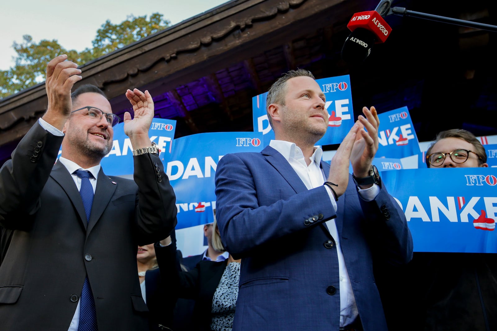 Michael Schnedlitz, right, and Christian Hafenecker of the Freedom Party of Austria cheer at the party headquarters in Vienna, Austria, Sunday, Sept. 29, 2024 upon seeing initial electoral projections. (AP Photo/Heinz-Peter Bader)