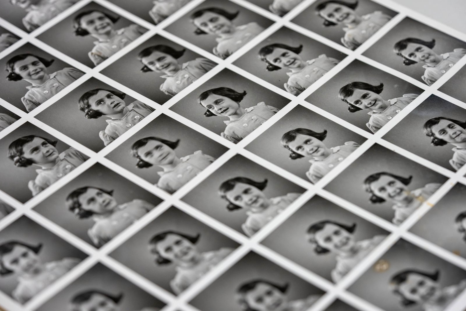 A sheet of pictures of Anne Frank is displayed in Amsterdam, Netherlands, Friday, Oct. 4, 2024, ahead of an exhibit in New York. (AP Photo/Peter Dejong)