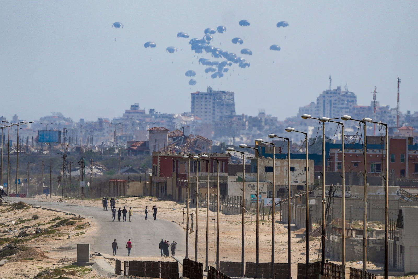 FILE - An aircraft airdrops humanitarian aid over the northern Gaza Strip, as seen from central Gaza, Tuesday, April 30, 2024. (AP Photo/Abdel Kareem Hana, File)