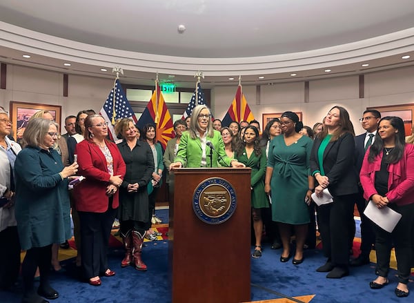 Arizona Gov. Katie Hobbs celebrates passages of abortion ballot measure surrounded by Democratic lawmakers and advocates on Monday, Nov. 25, 2024, at the State Capitol in Phoenix. (AP Photo/Sejal Govindarao)