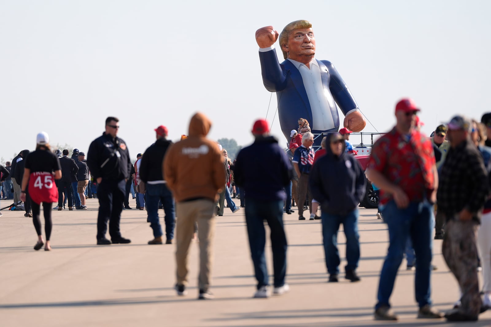 An inflatable Donald Trump is pictured in the parking lot of a campaign rally for the Republican presidential nominee former President as attendees arrive at Dodge County Airport, Sunday, Oct. 6, 2024, in Juneau, Wis. (AP Photo/Julia Demaree Nikhinson)