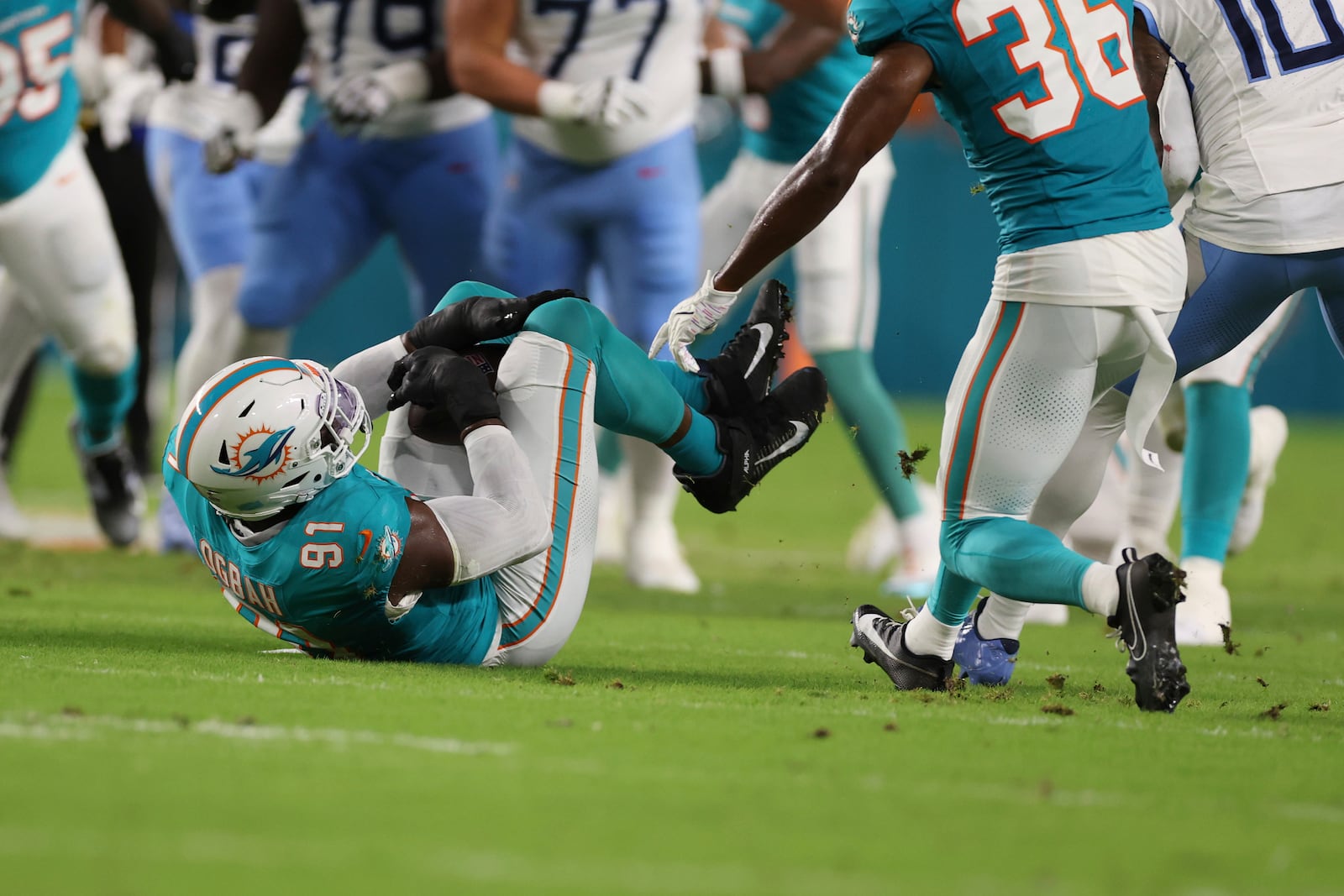 Miami Dolphins linebacker Emmanuel Ogbah (91) intercepts a pass during the first half of an NFL football game against the Tennessee Titans, Monday, Sept. 30, 2024, in Miami Gardens, Fla. (AP Photo/Brennan Asplen)