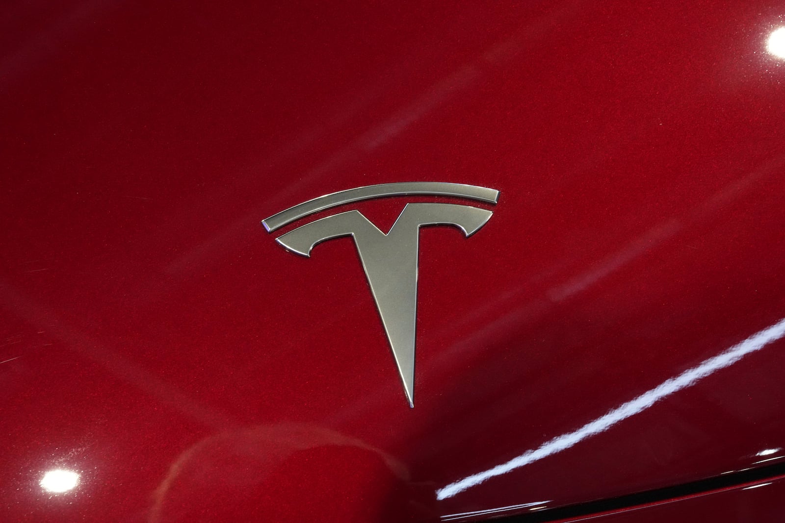 FILE - The logo of Tesla car is pictured at the Paris Auto Show, in Paris, Oct. 14, 2024. (AP Photo/Michel Euler, File)