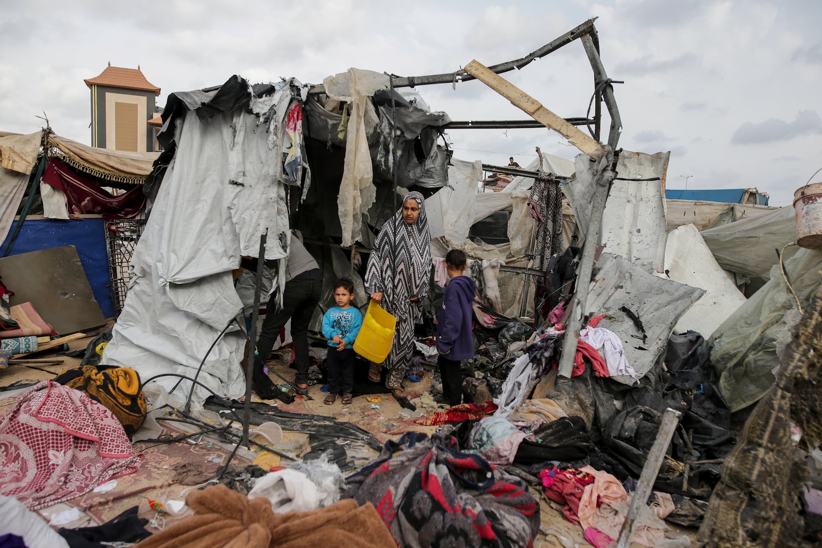 FILE - Displaced Palestinians inspect their tents destroyed by Israel's bombardment, adjunct to an UNRWA facility west of Rafah city, Gaza Strip, Tuesday, May 28, 2024. (AP Photo/Jehad Alshrafi, File)