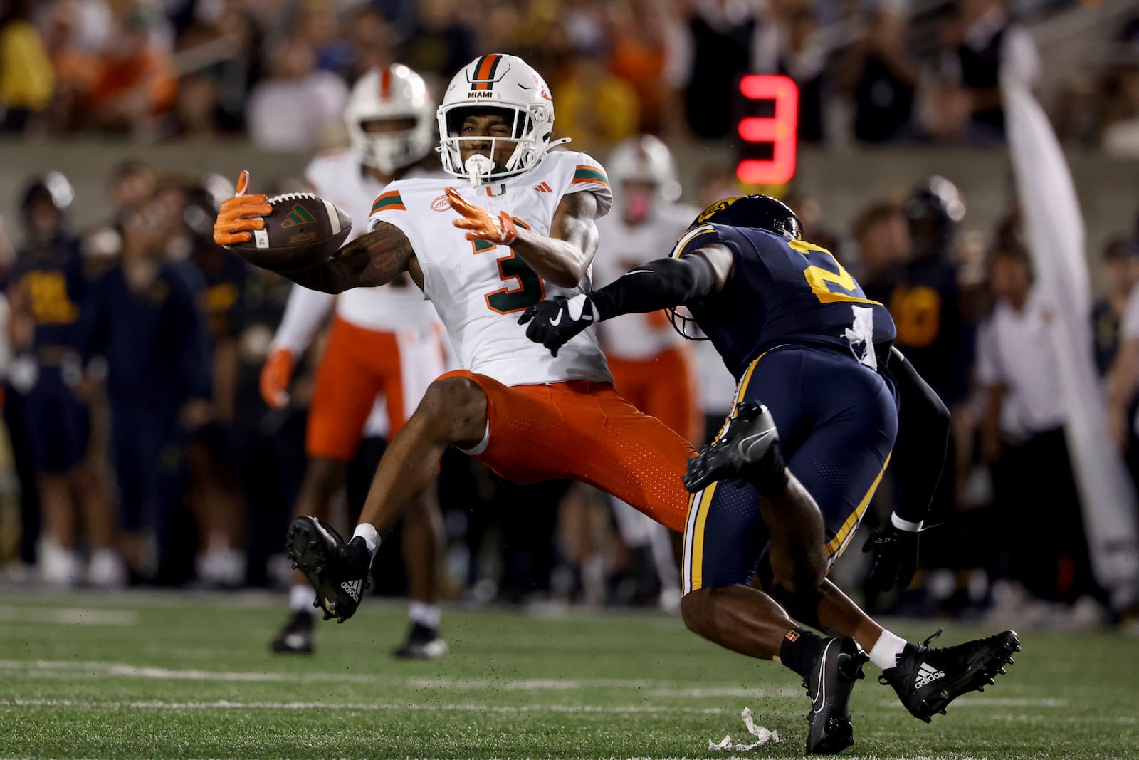 Miami wide receiver Jacolby George (3) is defended by California defensive back Craig Woodson (2) during the first half of an NCAA college football game in Berkeley, Calif., Saturday, Oct. 5, 2024. (AP Photo/Jed Jacobsohn)