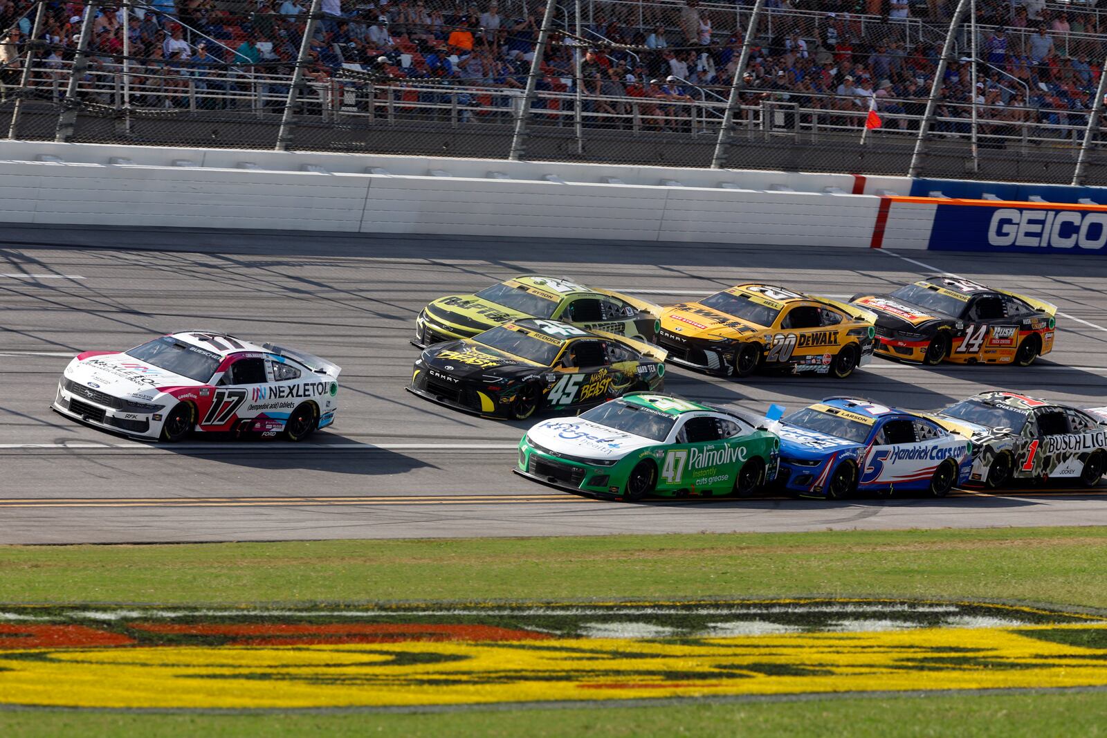 Driver Chris Buescher (17) leads a pack of cars to the end of Stage One during a NASCAR Cup Series auto race at Talladega Superspeedway, Sunday, Oct. 6, 2024, in Talladega, Ala. (AP Photo/ Butch Dill)